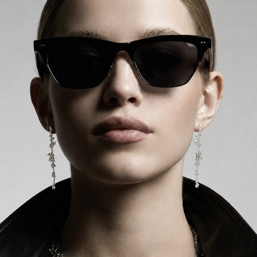 The FALLON STAGGERED STONE BAR DROP EARRINGS are made from plated brass and cubic zirconia.