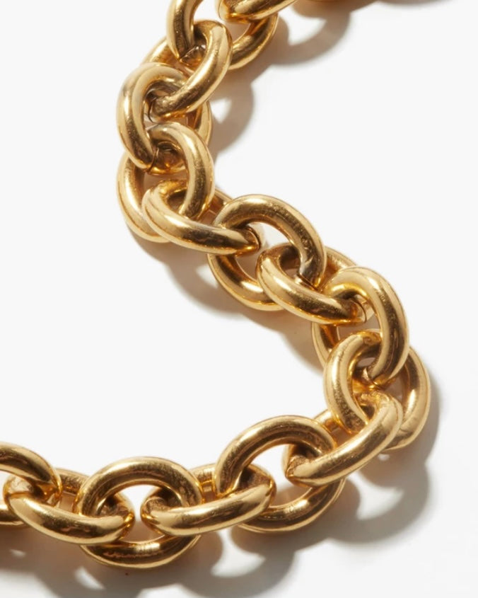 a gold chain bracelet on a white background