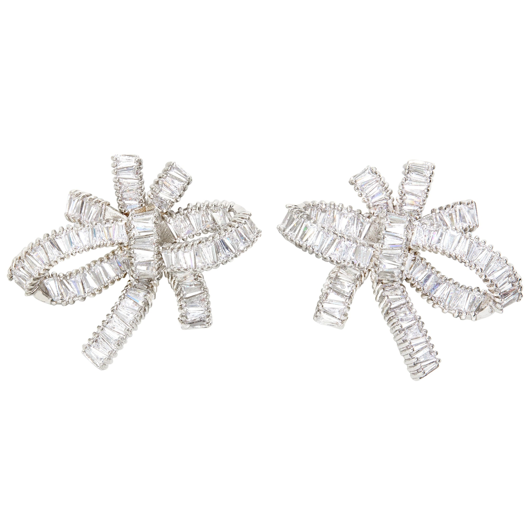 THE FALLON BAGUETTE BOW CLUSTER EARRINGS IN RHODIUM. Statement bow earrings made from plated brass and cubic zirconia.