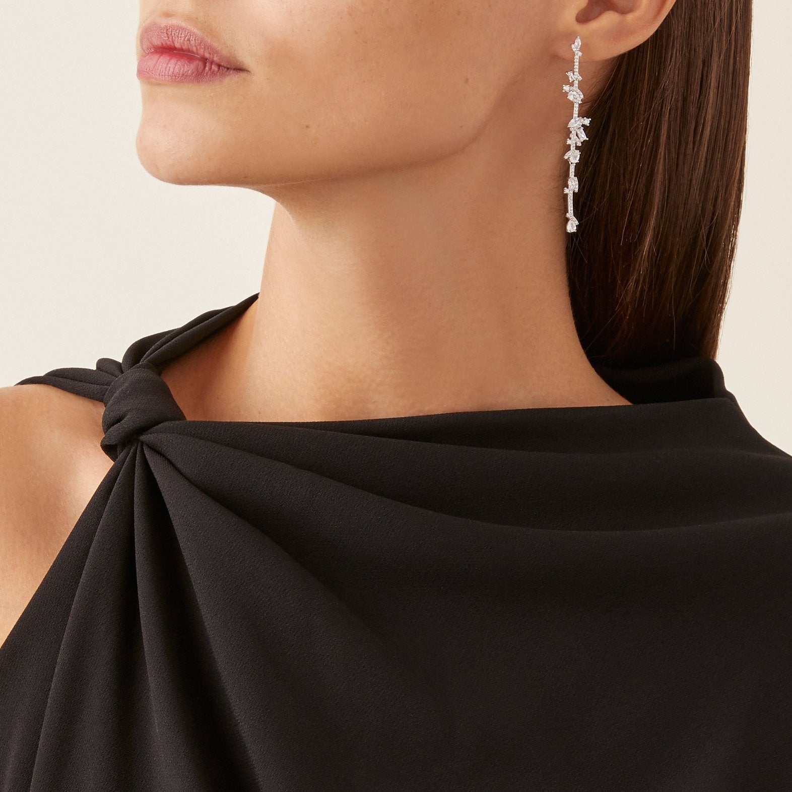 The FALLON STAGGERED STONE BAR DROP EARRINGS are made from plated brass and cubic zirconia.